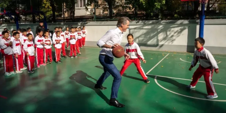 California Governor Gavin Newsom Accidentally Takes Down Student While Playing Basketball in China